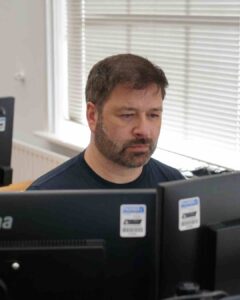Person working at computer desk.