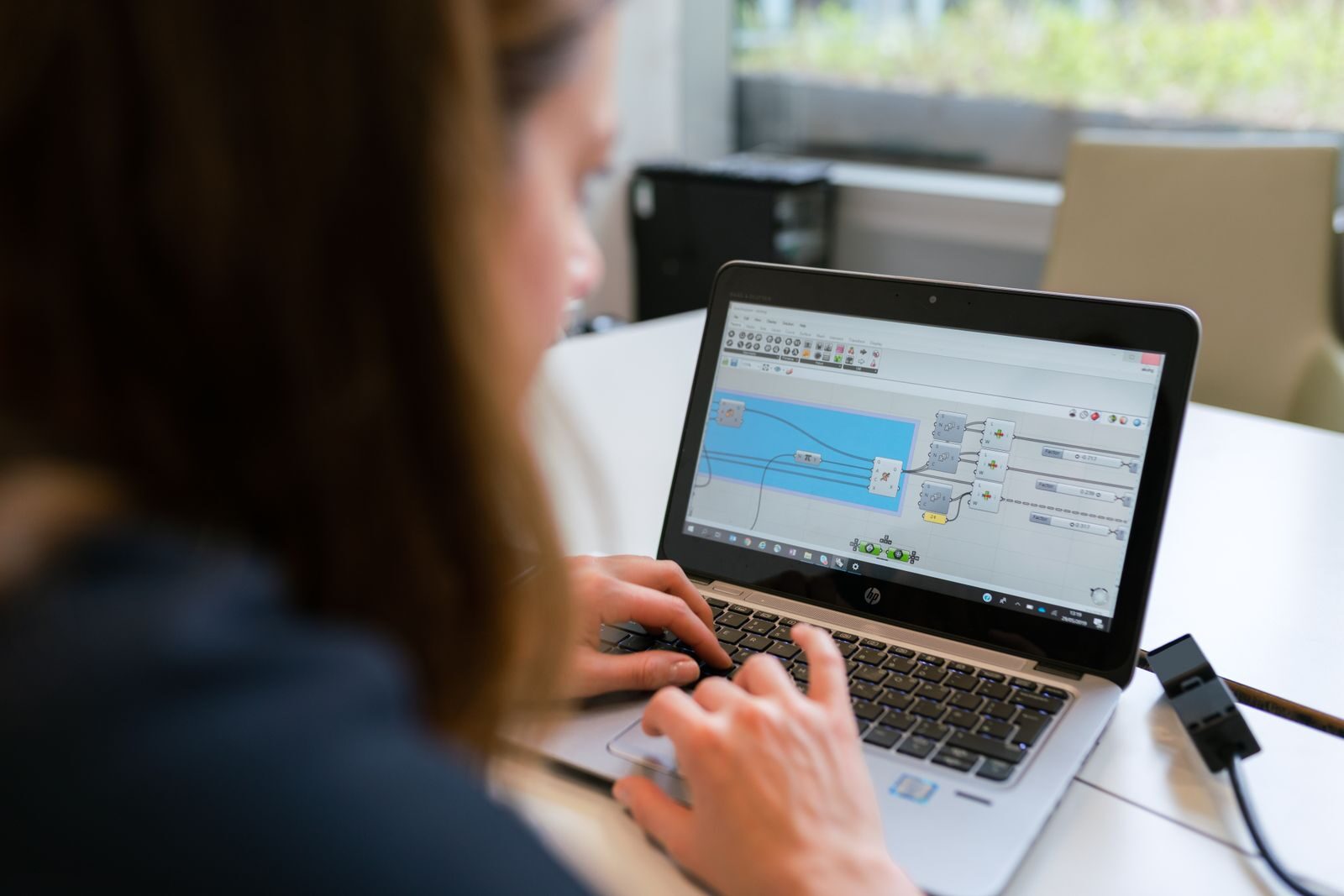 Woman working on a laptop reviewing account and access settings